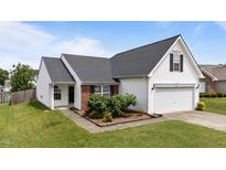 Charming single Gathering home featuring classic white siding, a brick accent, and well maintained landscaping at 4408 Jordan Oaks Way, Raleigh, NC 27604