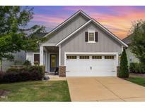 Charming single-Gathering home featuring a two-car garage, stone accents, and a well-manicured lawn at 47 Coventry Ln, Chapel Hill, NC 27516