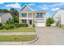 Charming two-story home with a well-manicured lawn and an attached two-car garage at 5011 Peachtree Town Ln, Knightdale, NC 27545