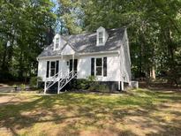Charming home with a well-maintained front yard, white siding, and a welcoming front porch at 503 Pine Run, Knightdale, NC 27545