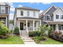 Charming two-story home featuring a welcoming front porch, landscaped yard, and inviting curb appeal at 586 Great Ridge Pkwy, Chapel Hill, NC 27517