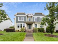 Charming two-story home featuring a well-maintained lawn and inviting facade with stone and landscaped entryway at 6444 Kit Creek Rd, Morrisville, NC 27560