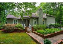 Charming home featuring a quaint porch, well-maintained landscaping and beautiful curb appeal at 69 Margaret Pl, Chapel Hill, NC 27516