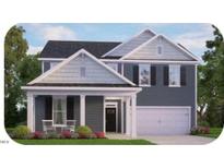 Charming two-story home featuring a covered porch, gabled roof, and attached two-car garage at 7592 Percussion Dr, Apex, NC 27539
