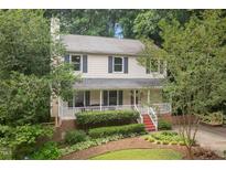 Charming two-story home with a welcoming front porch and beautifully landscaped front yard at 905 Balmoral Dr, Cary, NC 27511
