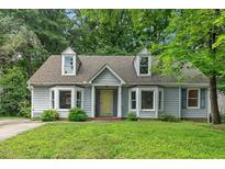Charming Cape Cod home with dormers and a well-maintained front lawn and mature trees at 1014 Laurens Way, Knightdale, NC 27545