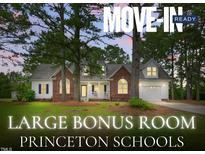 Charming single-Gathering home featuring brick and white siding, a welcoming porch, and a well-manicured front lawn at 106 Eagle Crest Ln, Princeton, NC 27569