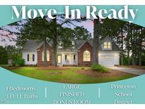 Charming brick and siding home with a welcoming front porch and well-manicured lawn at 106 Eagle Crest Ln, Princeton, NC 27569