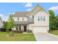 Charming two-story home with attached garage, well-manicured lawn, and inviting curb appeal at 110 Gallery Park Dr, Franklinton, NC 27525