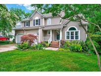 Charming two-story home featuring a landscaped front yard and inviting entryway with brick steps at 113 Fetzer Ct, Cary, NC 27513