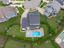 Stunning aerial view of a home featuring a pristine backyard pool and manicured landscaping at 120 Hazel Alder Ct, Holly Springs, NC 27540