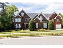 Beautiful brick home featuring manicured landscaping and a well-maintained lawn at 123 Trellingwood Dr, Morrisville, NC 27560