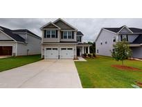Charming two-story home with a two-car garage and well-maintained lawn, perfect for families at 150 Hanover Ct, Clayton, NC 27527