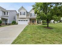 Charming two-story home featuring a well-manicured lawn and a two-car garage, enhancing curb appeal at 1720 Laurel Park Pl, Cary, NC 27511
