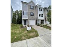 Charming new construction townhome with gray brick and siding and a one car garage at 1912 Fishamble St # 20, Fuquay Varina, NC 27526