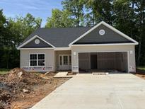 Charming, newly-constructed one story home featuring a two-car garage and neutral toned siding at 1995 Meadowview Dr, Graham, NC 27253