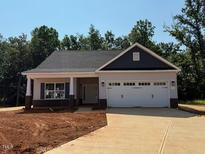 Charming single-story home features a two-car garage and a well-maintained front yard at 1998 Meadowview Dr, Graham, NC 27253