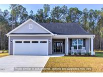 Charming single-story home featuring a two-car garage, covered entry, and well-manicured lawn at 1998 Meadowview Dr, Graham, NC 27253