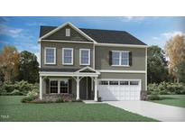 Charming two-story home with stone accents, white trim, and a welcoming covered entrance and attached two car garage at 2009 Birdhouse Ln, Wake Forest, NC 27587