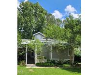 Charming home exterior with a manicured lawn, mature trees, and a welcoming entrance in a desirable neighborhood at 204 Kirkwood Dr, Chapel Hill, NC 27514