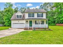 Charming two-story home with a well-manicured front yard and inviting front porch at 212 Spearhead Pl, Clayton, NC 27520