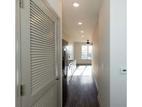 Hallway view leads to a kitchen with stainless steel appliances and ample natural light at 2226 Gathering Sq Ct, Fuquay Varina, NC 27526