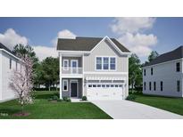 Charming two-story home with gray siding and a front-facing two car garage at 256 Meadowbark Bnd # 45, Garner, NC 27529