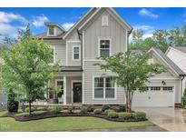 Beautiful two-story home with a manicured lawn, stone accents and an attached garage at 2721 Jazzy St, New Hill, NC 27562