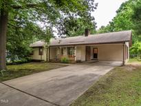 Ranch-style home with attached carport and long driveway at 307 Sunset Dr, Elon, NC 27244