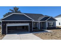 Charming single-story home with a mix of stone and vinyl siding and attached garage at 39 Braddock Ct, Garner, NC 27529