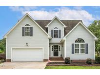Charming two-story home features a manicured lawn, attached garage, and classic architectural details at 40 Breckenridge Pl, Dunn, NC 28334