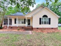 Charming single-Gathering home with a manicured lawn and a welcoming porch and black shutters at 419 Jera Dr, Garner, NC 27529