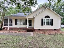 Charming single-story home with classic details and a well-maintained front yard with a blend of grass and decorative mulch at 419 Jera Dr, Garner, NC 27529