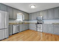 Updated kitchen featuring stainless steel appliances, granite countertops, and painted cabinets at 419 Jera Dr, Garner, NC 27529