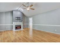 Inviting living room with hardwood floors, fireplace, and lots of natural light at 419 Jera Dr, Garner, NC 27529