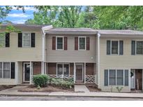 Charming townhome featuring neutral siding, brick accents, and well-maintained landscaping at 4658 Fawnbrook Cir, Raleigh, NC 27612