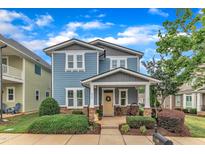 Charming two-story home with a welcoming front porch and professionally landscaped yard at 533 Duchart Ln, Fuquay Varina, NC 27526