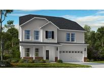 Charming two-story home featuring white siding, a two-car garage, and a welcoming front porch at 539 Claftin St, Sanford, NC 27330