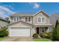 Charming two-story home with a well-maintained yard, attached garage, and craftsman-style details at 6101 Ricker Rd, Raleigh, NC 27610