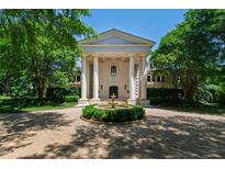 Front view of a sophisticated home featuring a circular drive and manicured landscaping at 6510 New Market Way, Raleigh, NC 27615