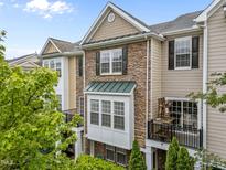 Beautiful exterior elevation with a stone facade and outdoor balcony, perfect for enjoying the neighborhood views at 9164 Wooden Rd, Raleigh, NC 27617