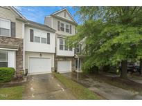 Charming townhome with two-car garage and well-maintained landscaping at 9808 Rainsong Dr, Wake Forest, NC 27587