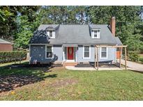 Charming home with a red front door and a well-maintained lawn and landscaping at 111 Mcdole Cir, Cary, NC 27511