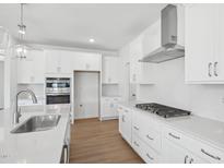 Bright kitchen with white cabinetry, stainless appliances, gas cooktop, and quartz countertops at 112 Moonflower Ln # Homesite 267, Wilson's Mills, NC 27520