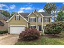 Traditional two-story home with verdant lawn, attached garage and manicured landscaping at 1237 Shirehall Park Ln, Wake Forest, NC 27587