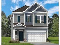 Charming two-story home with gray siding, white trim, and a two-car garage offers curb appeal at 128 Bruce Dr, Dunn, NC 28334