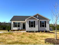 Charming single-story home featuring classic architectural details and a well-manicured front lawn at 140 Brookhaven Dr, Spring Hope, NC 27882