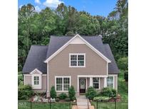 Charming home with manicured lawn, black fence, and beautiful landscaping at 151 Bridge St, Hillsborough, NC 27278