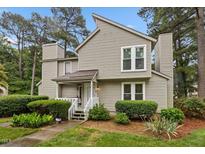 Charming two-story home with a well-manicured lawn and mature trees, and private front entrance at 151 Lake Pine Dr, Cary, NC 27511