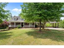 Charming brick home with inviting front porch and well-manicured lawn and a convenient covered parking area at 1852 Gwyn Rd, Burlington, NC 27217